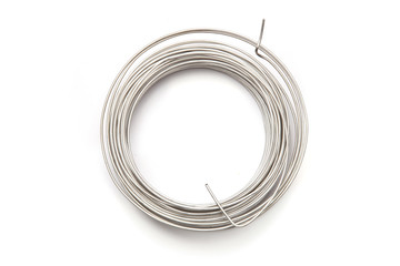 Coil of stainless steel wire isolated on white background.  Stack of stainless steel metal wire top...
