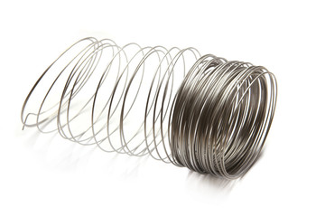 Coil of stainless steel wire isolated on white background.  Stack of stainless steel metal wire.