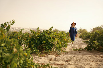 Obraz premium Nature. Woman In Vineyard Field Between Green Bushes