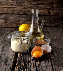 Delicious mayonnaise sauce  on wooden background. Homemade mayonnaise. Sour cream.