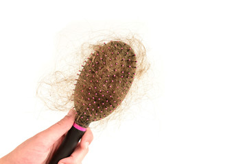 Hair loss. Comb with hair isolated on white background. 