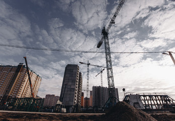 View of the construction site with cranes and high-rise residential buildings