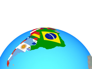 Latin America with national flags on political globe.
