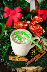 cup of drink with marshmallows on christmas background