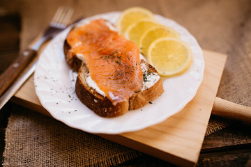 Smoked salmon with cheese toasted bread lemon and yogurt dip