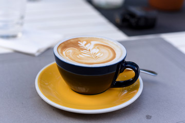 A cup of cappuccino coffee on the table