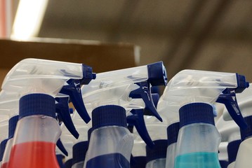 white plastic bottles with spray bottles in a supermarket
