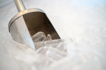 Close up of Stainless steel bar ice scoop in Ice bucket.