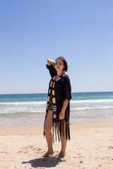 Beautiful young woman on the beach in summer. Black sea and blue sky