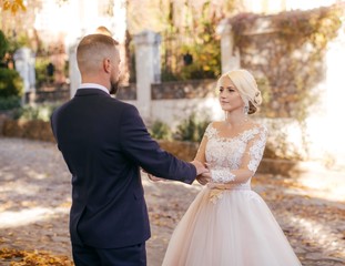 Fototapeta premium Happy bride and groom on their wedding in autumn garden