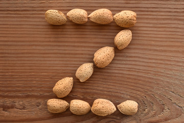 the letter Z shaped with almonds on wood