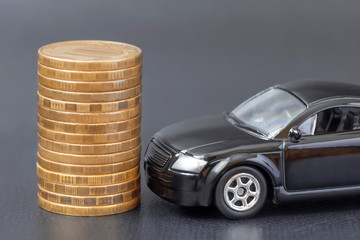stack of coins and car on black background. saving money for automobile transport and manage for...
