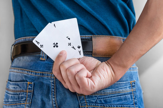 man hold two aces behind his back. Best gamble in poker or lucky hand concept. player going all in with pocket aces