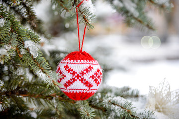 Closeup of red bauble hanging from a decorated Christmas. Merry Christmas and Happy New Year  tree