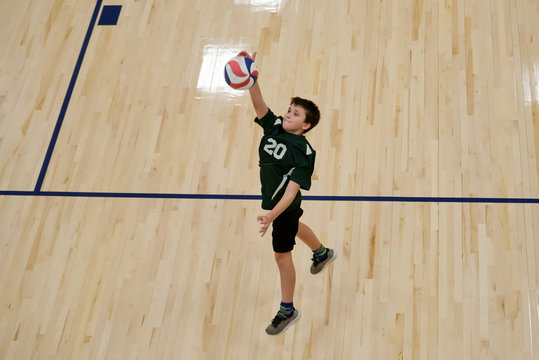 Volleyball player jumps to hit the ball