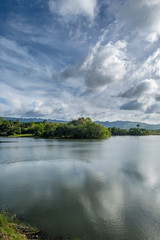 Fototapeta na wymiar Pilar dam. Lake water, sun and clouds. Bohol