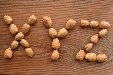 the letters X,Y,Z shaped with almonds on wood