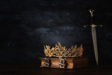 low key image of beautiful queen/king crown and sword. fantasy medieval period.