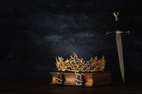 low key image of beautiful queen/king crown and sword. fantasy medieval period.