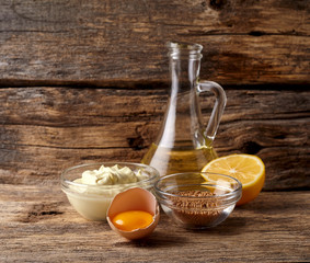 Delicious mayonnaise sauce  on wooden background. Homemade mayonnaise. Sour cream.