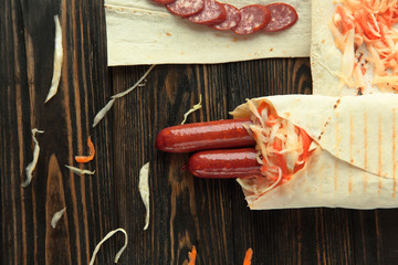 sliced salami and Shawarma on wooden background .photo with copy