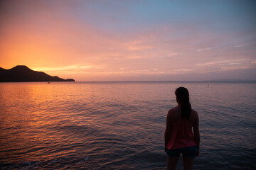 girl watching sunset at costa rica beach