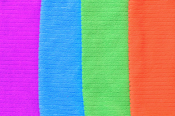 The texture of four colored towels purple, blue , green, orange. Horizontal photography