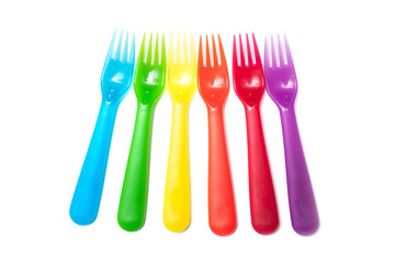 set of colorful baby plastic forks on white background