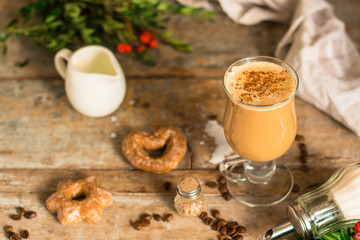 coffee with milk - cappuccino (cup of coffee) arabica in a transparent cup on a wooden table. Top view. copy space