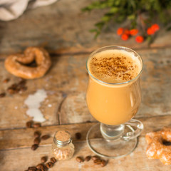 coffee with milk - cappuccino (cup of coffee) arabica in a transparent cup on a wooden table. Top view. copy space