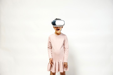 A little girl playing with VR headset