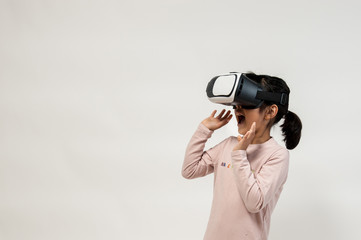A little girl playing with VR headset