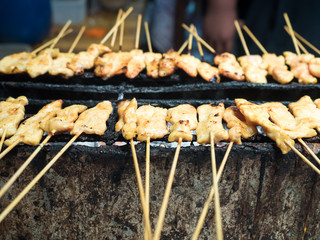 Toast pork with bamboo stick insert on iron charcoal stove for sale
