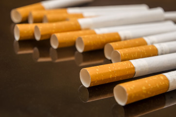 scattered cigarettes on the black glass table