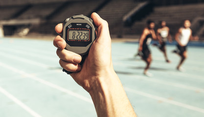 Man keeping time at a running race using stop watch