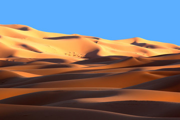 Moroccan Sahara sand dunes and shadows at sunset