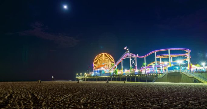Santa Monica Pier Time-lapse Night on Beach Wide. a time-lapse of the Santa Monica Pier wide angle from the beach perspective with the bright moon
