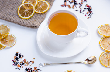Orange herbal flavored christmas tea with cinnamon and cardamom honey white cup on a white wooden table