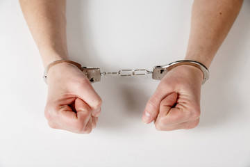 Womans hands in handcuffs.