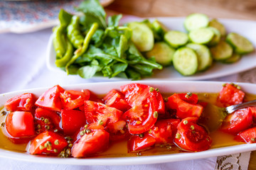 Tomatos and cucumbers on the table.