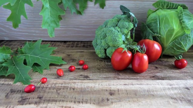 fresh broccoli, tomatoes and cabbige on the wooden background