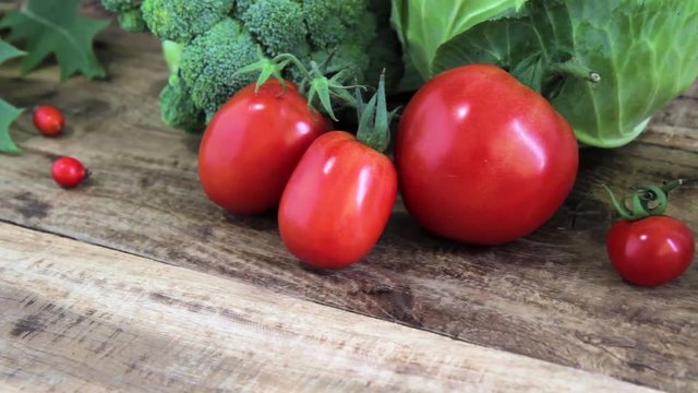 fresh broccoli, tomatoes and cabbige on the wooden background