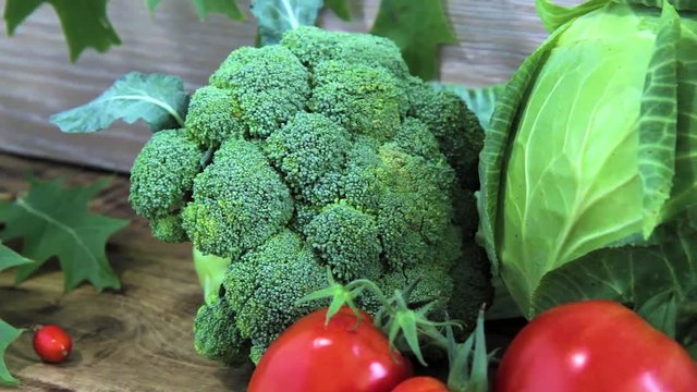 fresh broccoli, tomatoes and cabbige on the wooden background