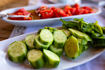 Tomatos and cucumbers on the table.