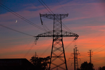 Electrical lines under a night sky with moon