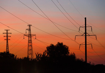 Electrical lines under a night sky with moon