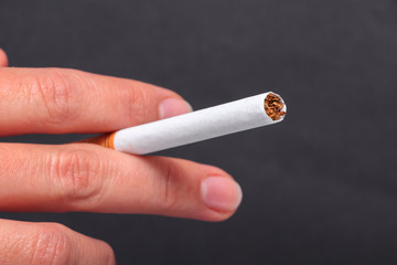 Woman holding cigarette between fingers