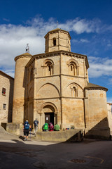 Pilgrims in front of the Church of Santo Sepulcro, Church of the Holy Sepulchre in Torres del Rio, Navarre Spain on the Way of St. James, Camino de Santiago