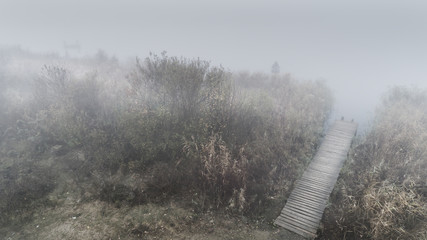 Cold autumn foggy morning near a beautiful fishing lake in Sic. Romania