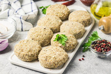 Raw meat fritters and ingredients on a cutting board, ready for cooking. Selective focus, space for text.